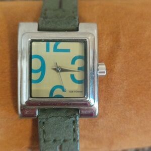 Tokyobay khaki green women's silver bezel watch.